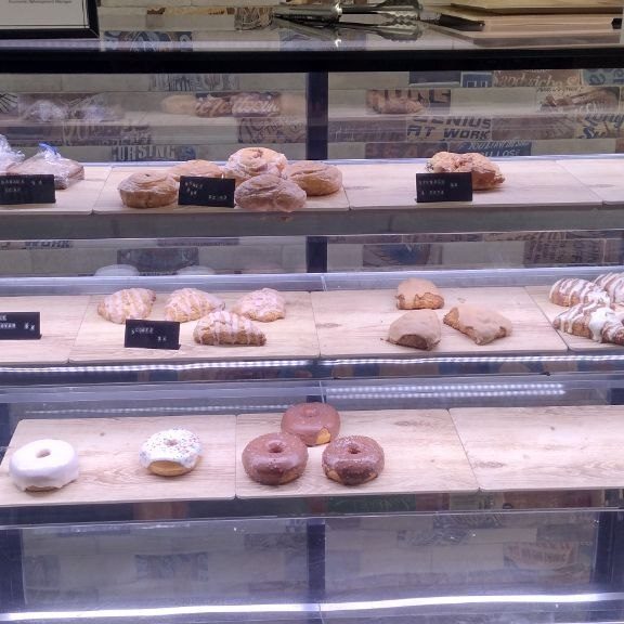 Pastry case with croissants, scones, and donuts